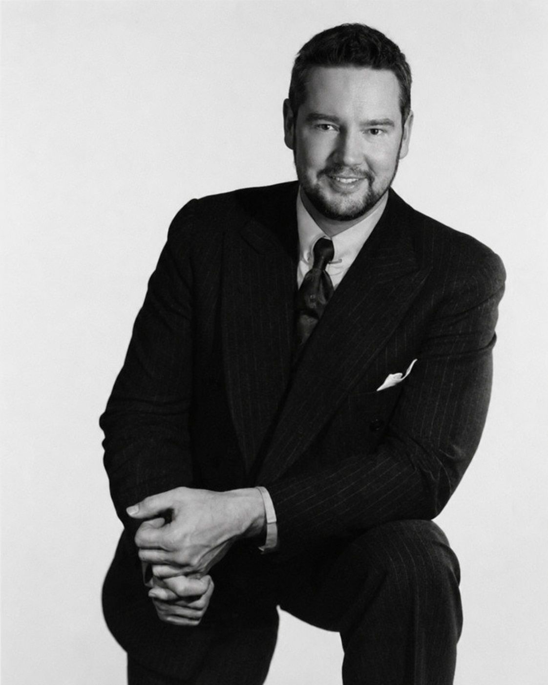 Franck Brunet in a suit, black-and-white studio portrait.